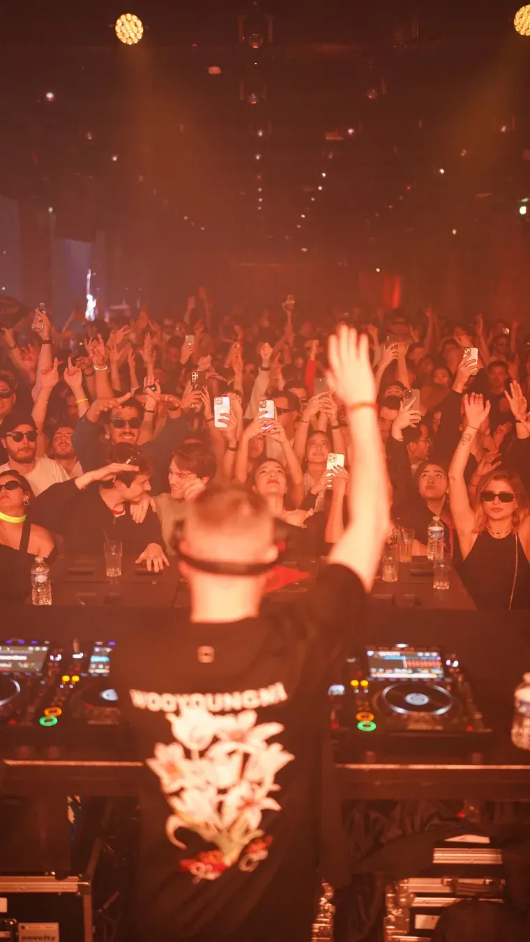 DJ in orange light at Bridge