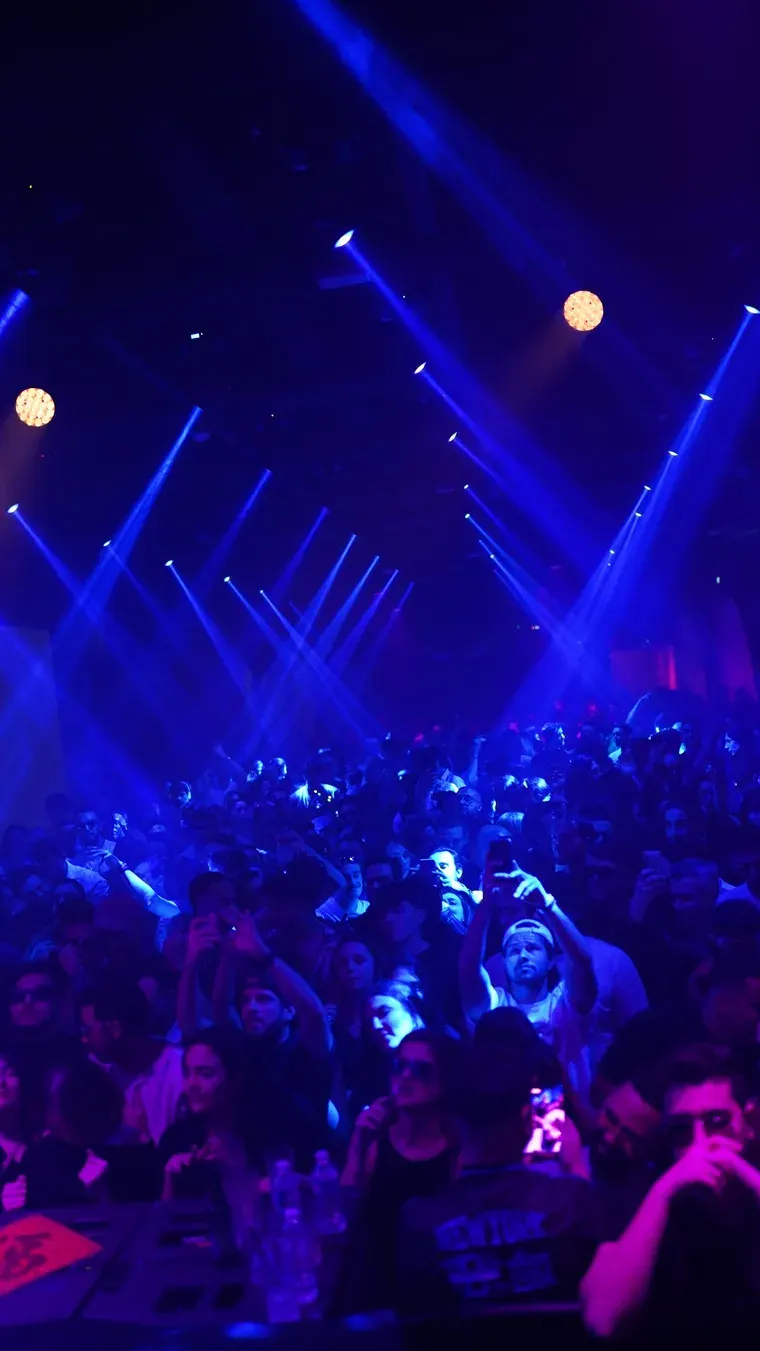 Blue light beams over the dance floor