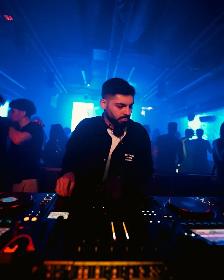 DJ in cyan light
